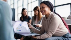 Person sitting in an office while holding a computer