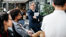 Numerous employees sitting in a courtyard