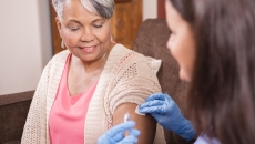 Nurse with a syringe and a patient Nurse with a syringe and a patient