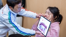 A dentist screening a person's gum using an AI-powered mobile application A dentist screening a person's gum using an AI-powered mobile application