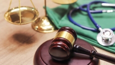 A gavel next to a stethoscope A gavel next to a stethoscope