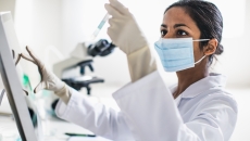 Scientist analyzing contents of test tube Scientist analyzing contents of test tube