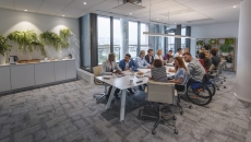 Numerous people sitting around a table Numerous people sitting around a table