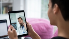 Person talking to a healthcare provider on a tablet Person talking to a healthcare provider on a tablet