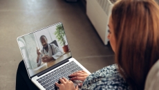 Person on a laptop speaking with a healthcare professional Person on a laptop speaking with a healthcare professional