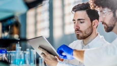 Two people looking at a tablet in a laboratory