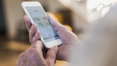 Smartphone health app A close-up image of a person using a digital health app on a smartphone.
