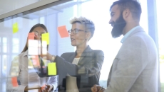People looking at a board with post-it notes People looking at a board with post-it notes