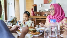 Family sitting at a table eating dinner Family sitting at a table eating dinner