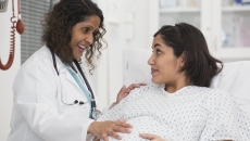 Healthcare professional consulting with pregnant patient Healthcare professional consulting with pregnant patient