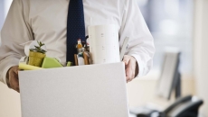 A worker holding a box with belongings A worker holding a box with belongings