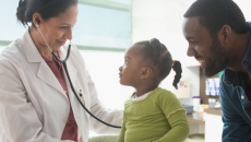 A parent with a toddler at a doctor's appointment