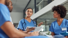 A group of medical practitioners having a discussion in a hospital. A group of medical practitioners having a discussion in a hospital.