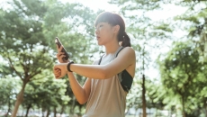 A person checking their fitness tracker data on their mobile phone A person checking their fitness tracker data on their mobile phone