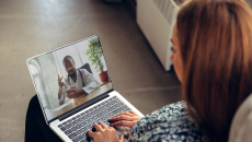 A woman talking to a doctor through a video chat on her laptop. A woman talking to a doctor through a video chat on her laptop.
