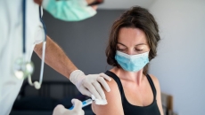 A woman receiving a vaccine. A woman receiving a vaccine.