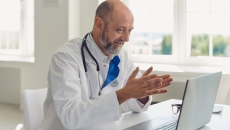 Healthcare provider on their computer speaking with someone
