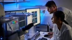 Laboratory scientists reviewing a computer-aided analysis Laboratory scientists reviewing a computer-aided analysis