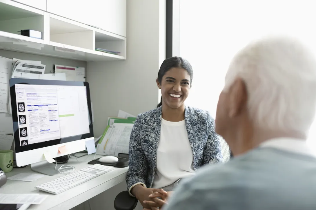 A provider having a conversation with an older patient.