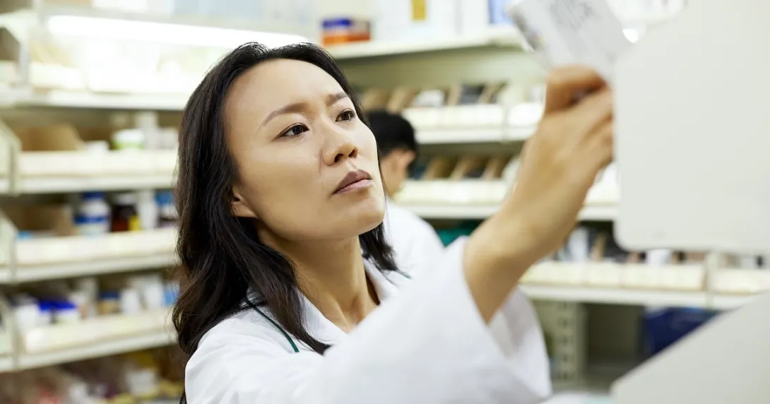 Pharmacist checking a medication package Pharmacist checking a medication package