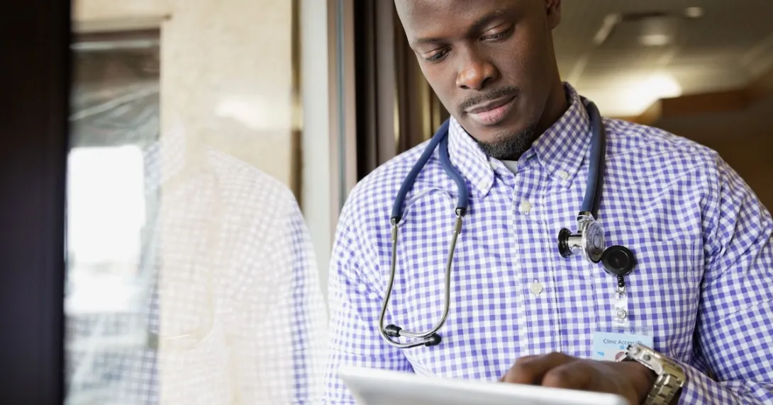 Healthcare provider looking at a computer Healthcare provider looking at a computer