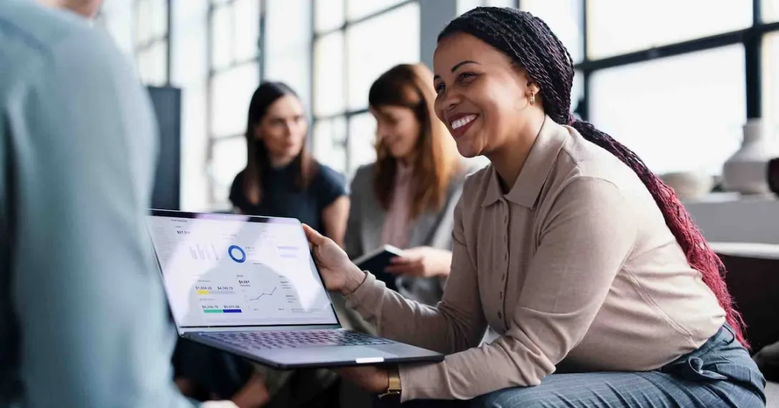 Person sitting in an office while holding a computer