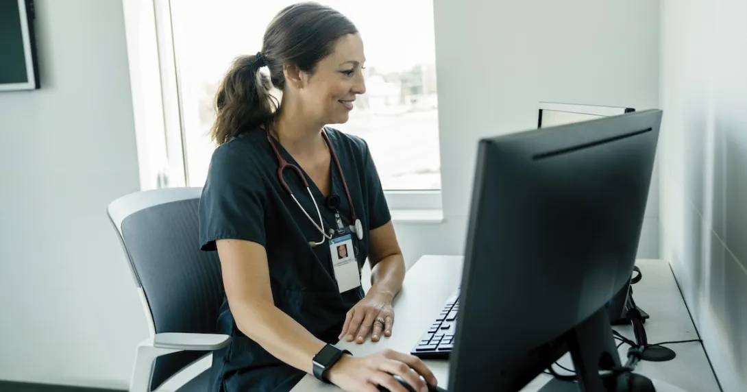Healthcare professional looking at a PC screen