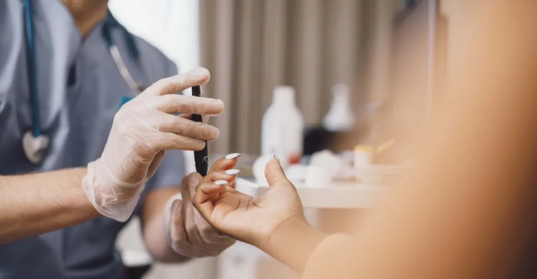 Doctor taking a patient's blood sample in a clinic