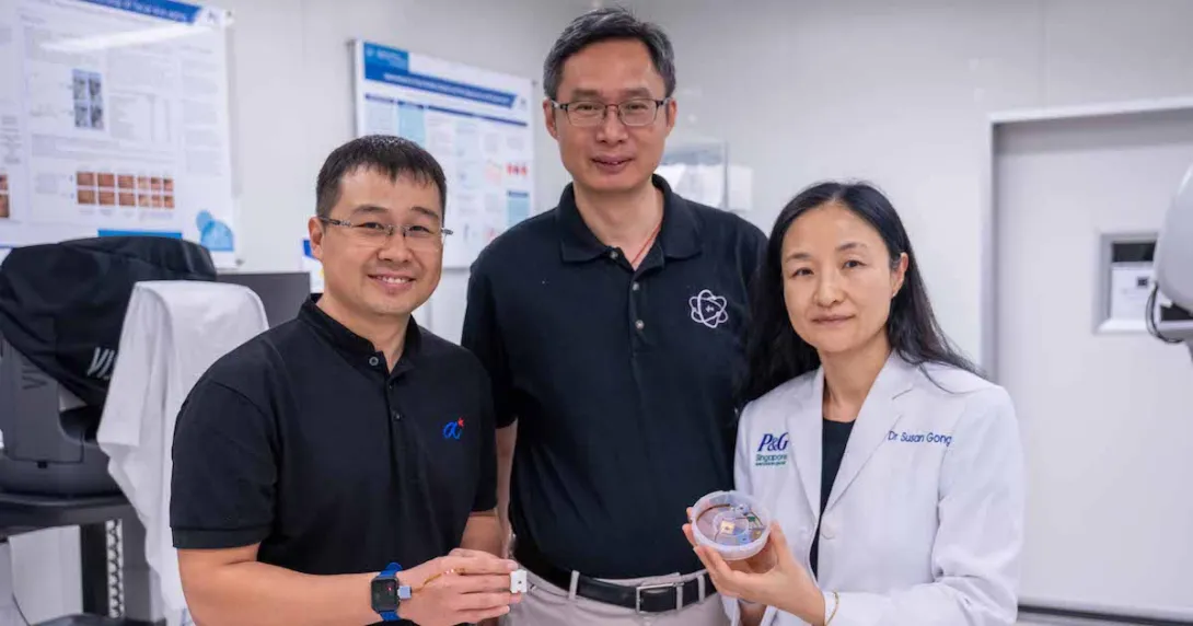 Representatives from NTU Singapore, Procter &amp; Gamble, and Agency for Science, Technology and Research pose side-by-side while showing the HapSense ring-type device for skincare cosmetic product analysis.