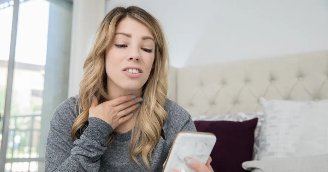 A woman participates in a telemedicine visit via smartphone
