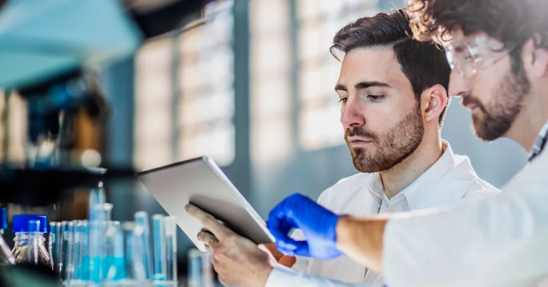 Two people looking at a tablet in a laboratory