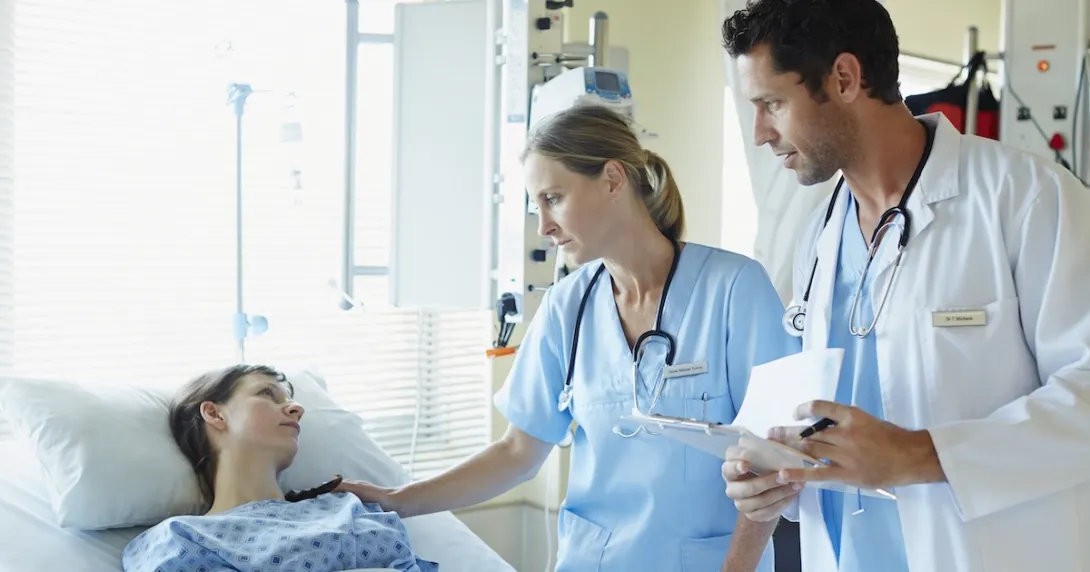 Healthcare professionals talking to a patient in a hospital