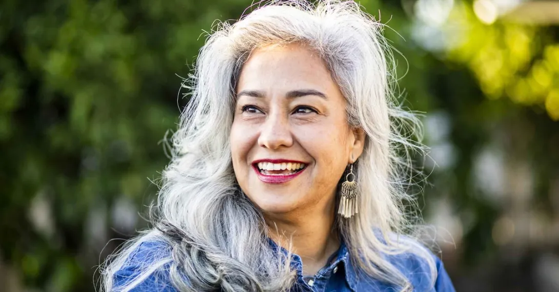 Person with gray hair smiling