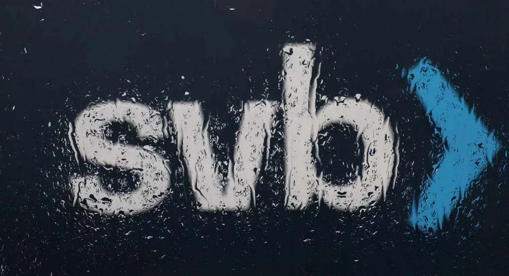 The Silicon Valley Bank (SVB) logo is seen through a rain covered window in front of the SVB headquarters.