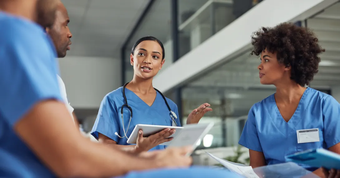 A group of medical practitioners having a discussion in a hospital.