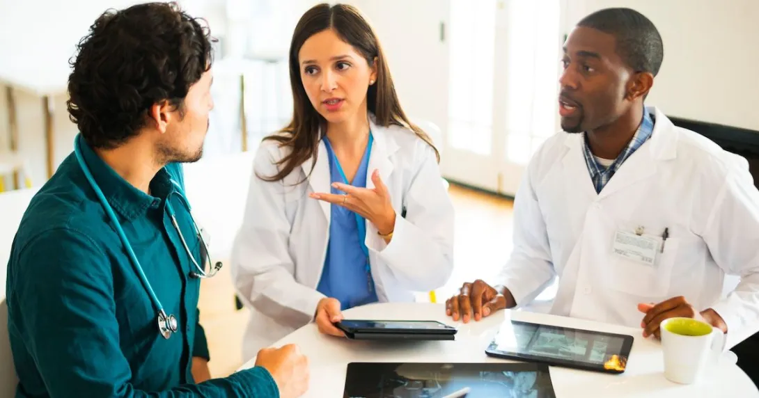 Doctors talking together with digital tablets and X-rays.