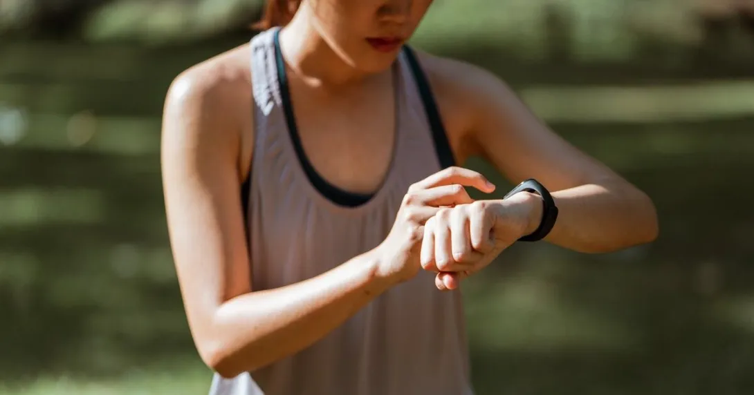 A runner checking on their smartwatch