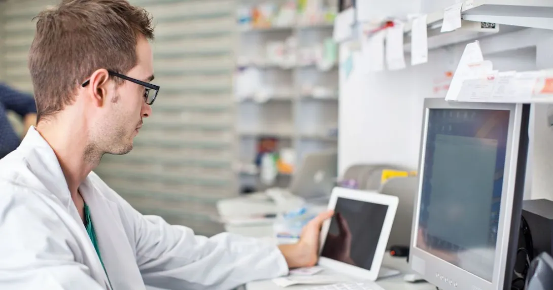A pharmacist working at a desk
