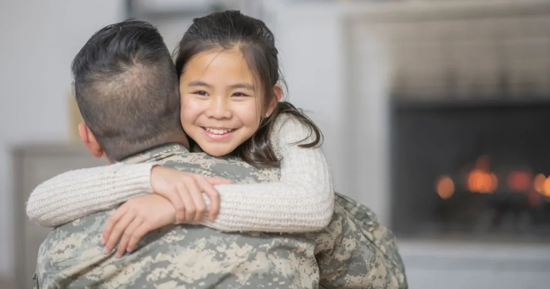Solider hugging another person