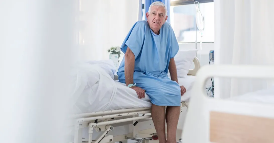 Patient in a hospital sitting on their bed