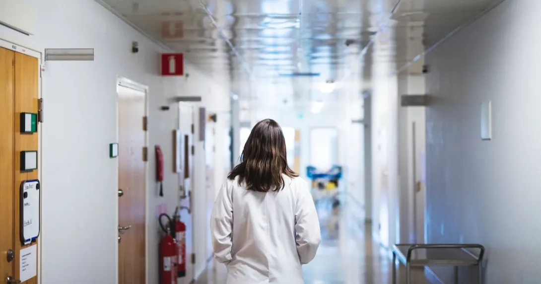 Healthcare worker walking down the hallway in a hospital