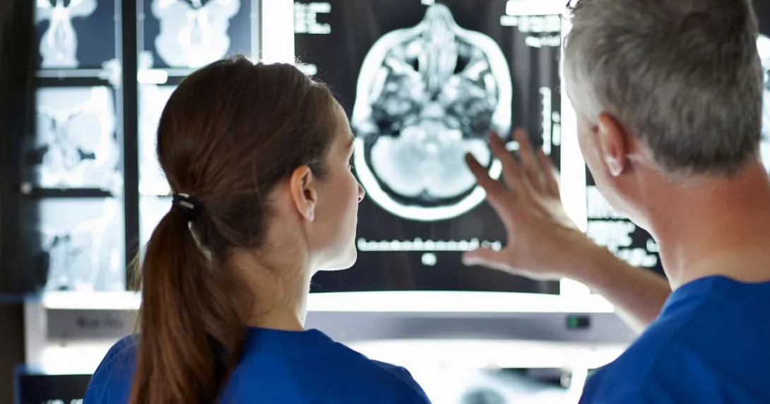 Two radiologists analysing a brain scan